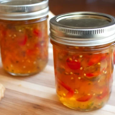 Homemade jalapeno pepper jam recipe with bell peppers in mason jars.
