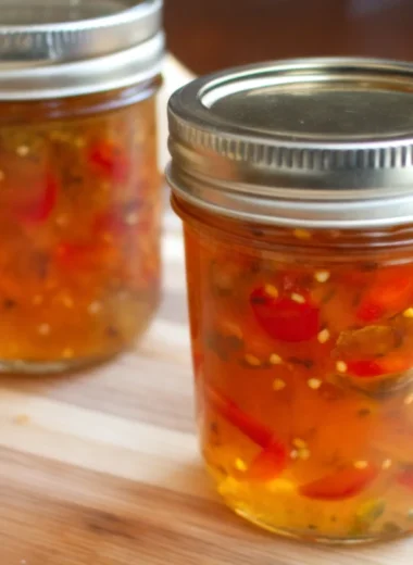 Homemade jalapeno pepper jam recipe with bell peppers in mason jars.