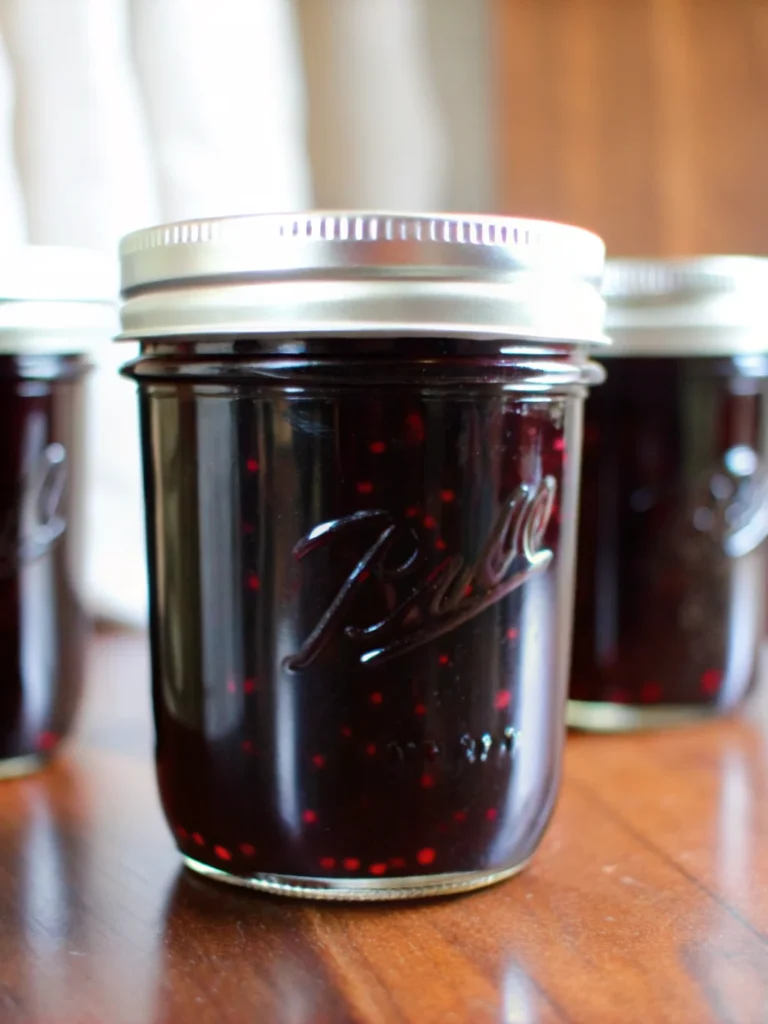 Black raspberry jam recipe in half-pint jars with deep purple color, homemade small-batch jam made with liquid pectin