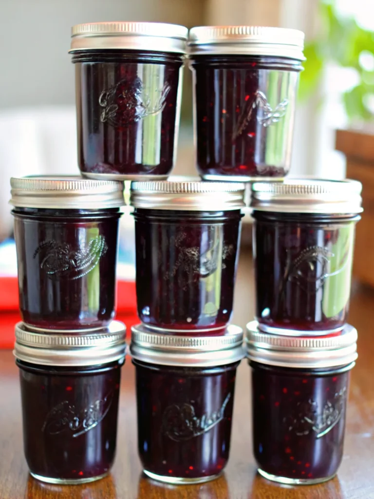 Black raspberry jam recipe in half-pint jars with deep purple color, homemade small-batch jam made with liquid pectin