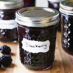 Homemade blackberry jam recipe without pectin in a glass jar with fresh berries.