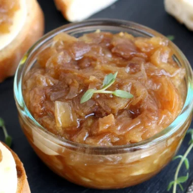 Homemade caramelized onion jam recipe in glass jar with golden-brown color showing perfect jam consistency and texture